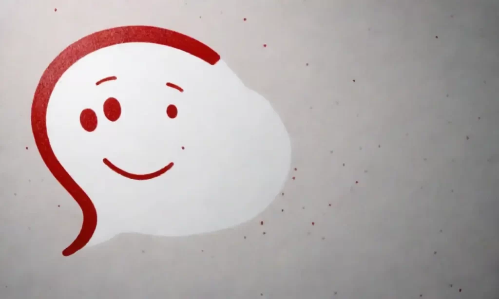 Se observa una explosión de puntos grises y un rostro sonriente con preguntas